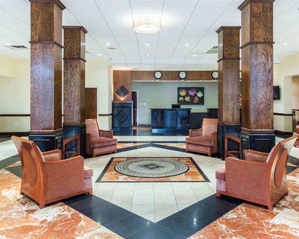 a lobby with chairs and a reception desk at Clarion Hotel Somerset - New Brunswick in Somerset