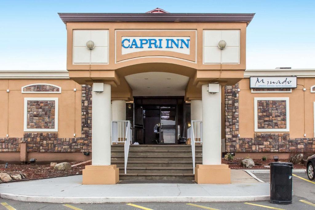 a building with the entrance to a carrintm at Rodeway Capri Inn in Little Ferry