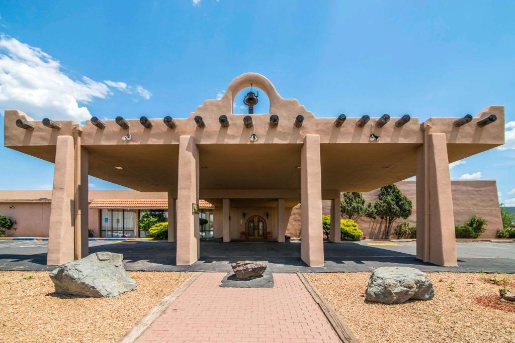 a building with a roof with rocks in front of it at Quality Inn in Taos