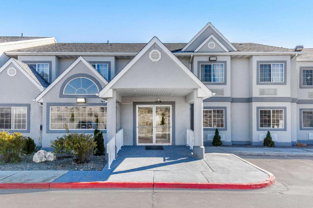 a large white house with a red driveway at Quality Inn & Suites Elko in Elko