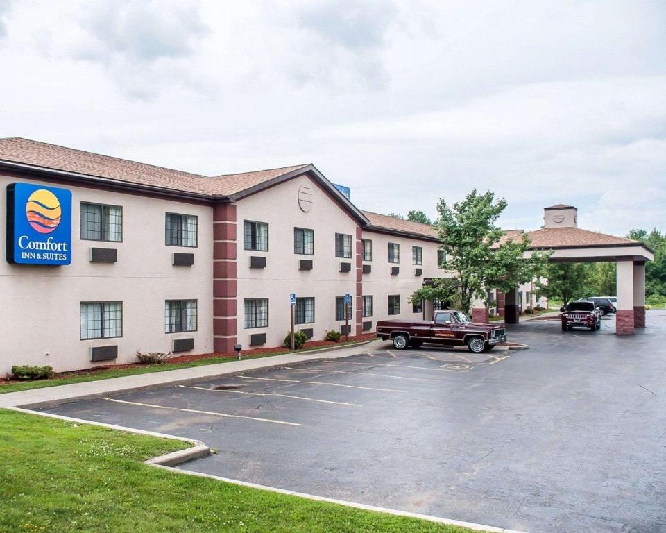 a hotel with a truck parked in a parking lot at Comfort Inn & Suites in Hamburg