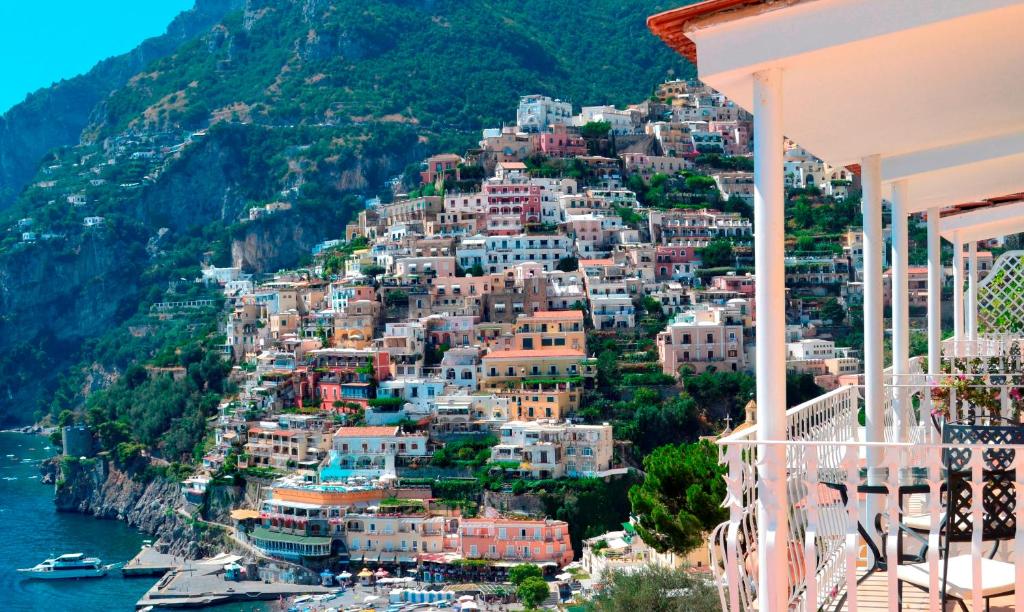 a scenic view of a city with houses and boats at Hotel Marincanto in Positano