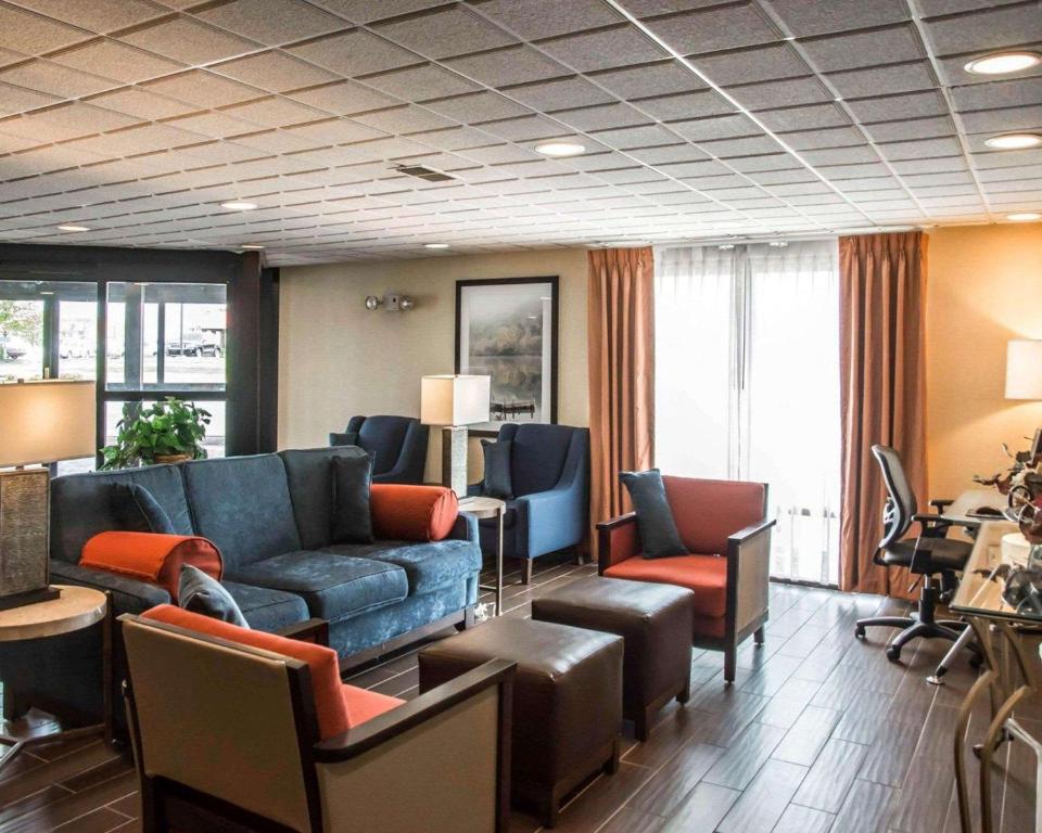 a living room with a blue couch and chairs at Quality Inn Springboro West in Springboro