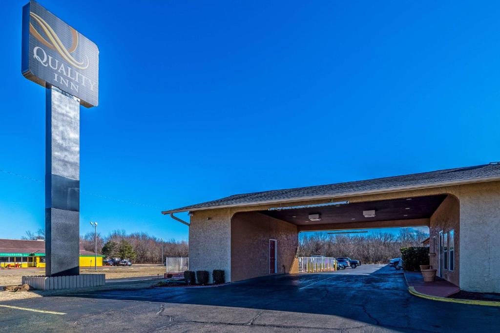 a gas station with a sign in front of it at Quality Inn Glenpool - Tulsa in Glenpool