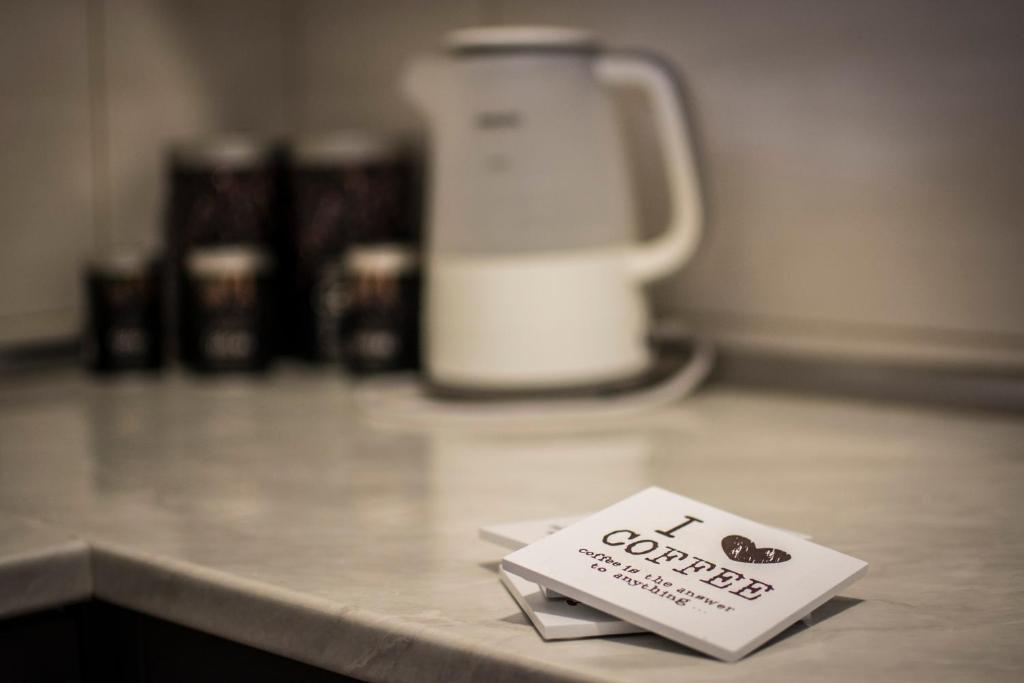 a sign sitting on top of a counter with a blender at Apartmani F&A in Zlatibor