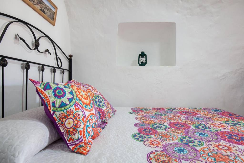 Postel nebo postele na pokoji v ubytování Casa Cueva Calatrava