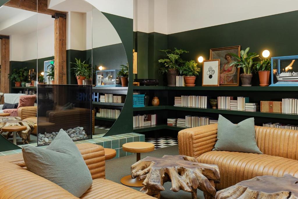 a room with two couches and a book shelf at Palihotel Seattle in Seattle