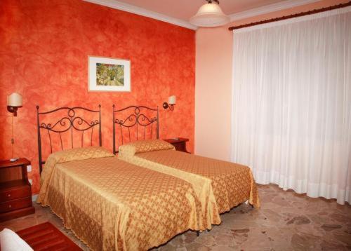 
a hotel room with a bed and two lamps at Costa Azzurra in Giardini Naxos
