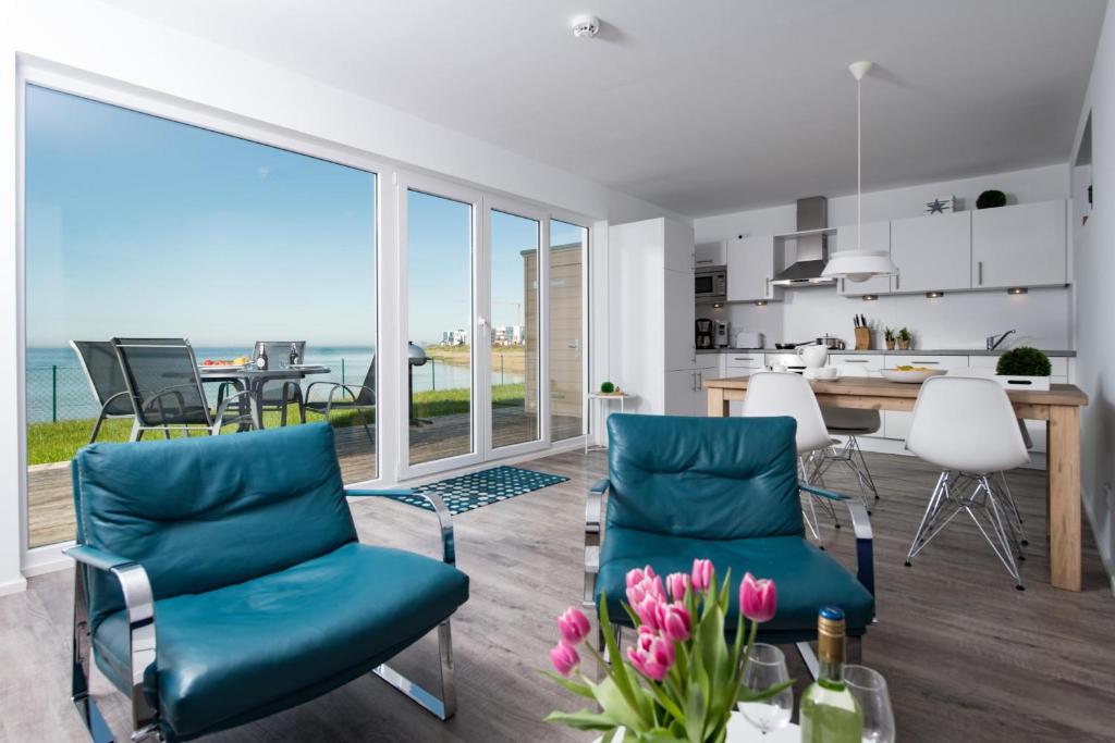 a kitchen and living room with a view of the ocean at Albatros in Olpenitz