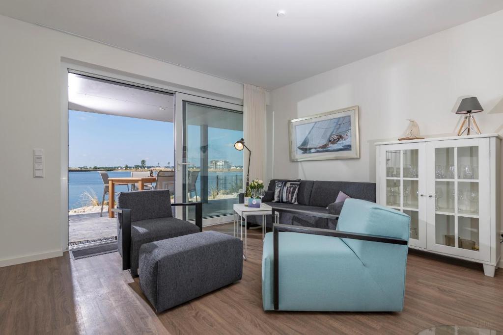 a living room with a view of the ocean at Hafenheimat in Olpenitz