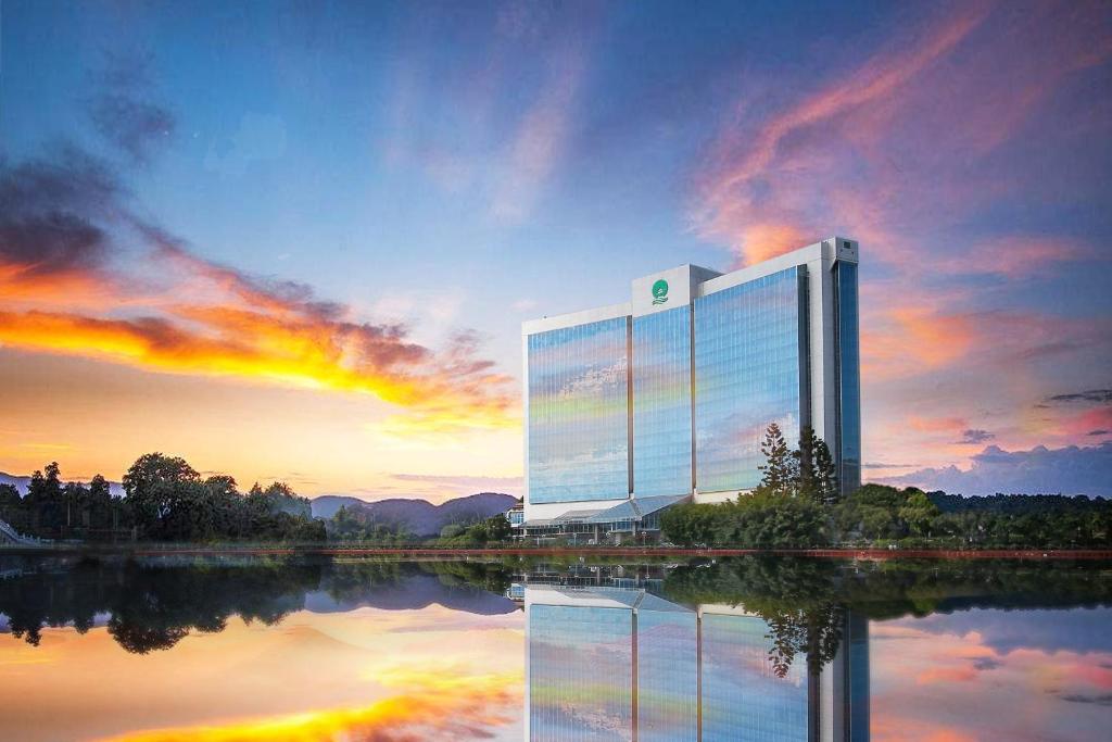 a large building with a reflection in the water at Fuzhou Lakeside Hotel in Fuzhou