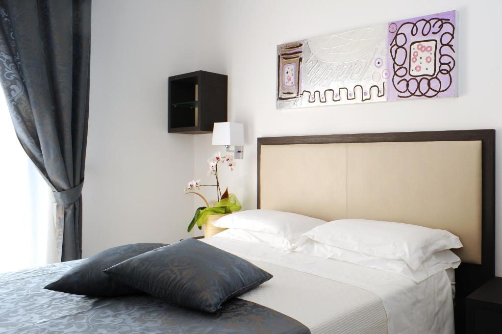 Postel nebo postele na pokoji v ubytování Hotel Ambassador