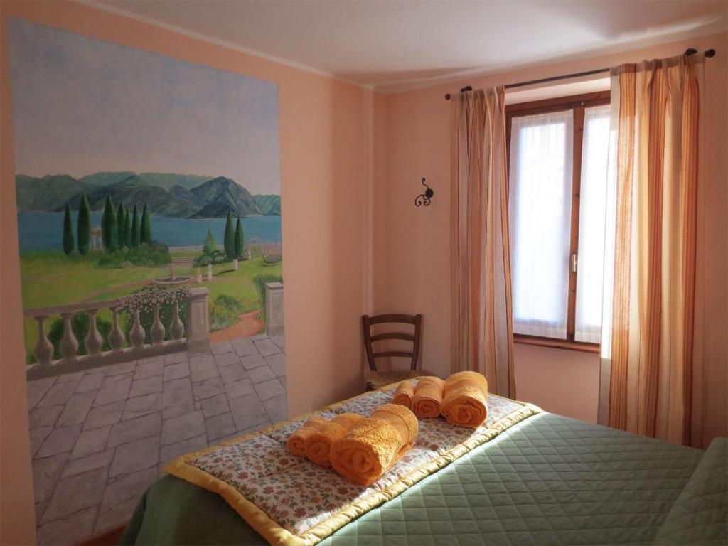 a bedroom with a bed with b towels on it at La Ca' Di Sala in Margno