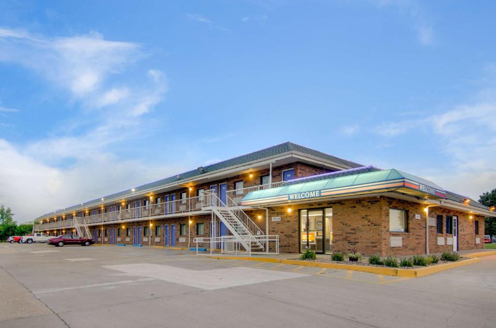 a large brick building with a staircase in a parking lot at Motel 6-Salina, KS in Salina