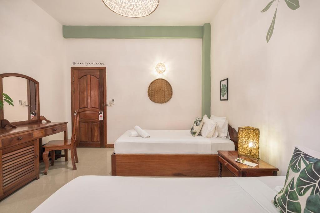Postel nebo postele na pokoji v ubytování Babel Siem Reap Guesthouse