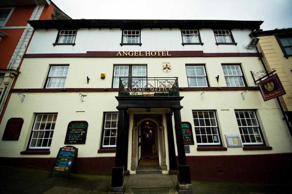 a large white building with a balcony in front of it at The Angel Hotel in Helston