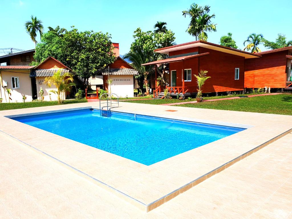 a swimming pool in front of a house at Jungle View Resort in Ko Chang