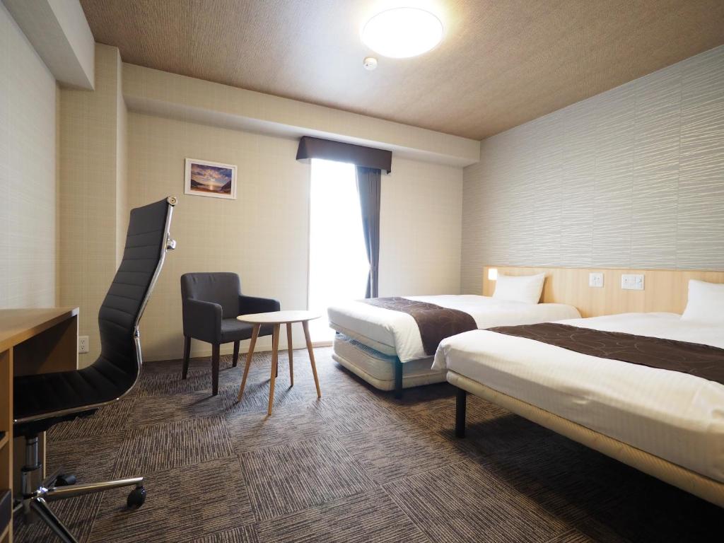 Postel nebo postele na pokoji v ubytování TABINO HOTEL Sado