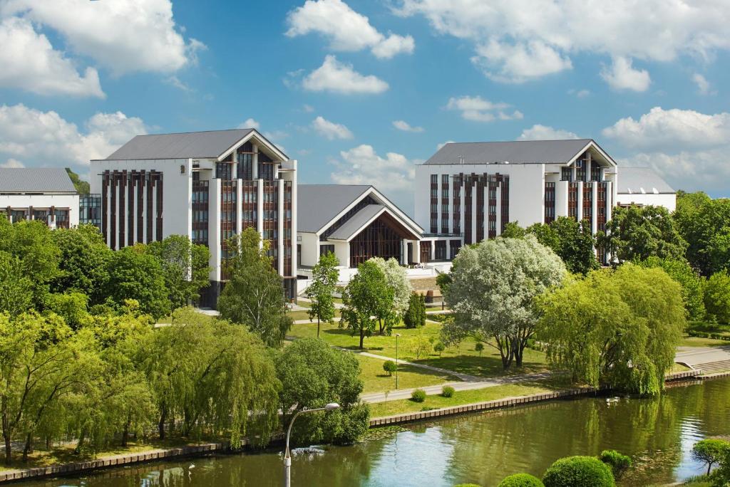 a rendering of a campus with a river and buildings at Beijing Hotel Minsk in Minsk