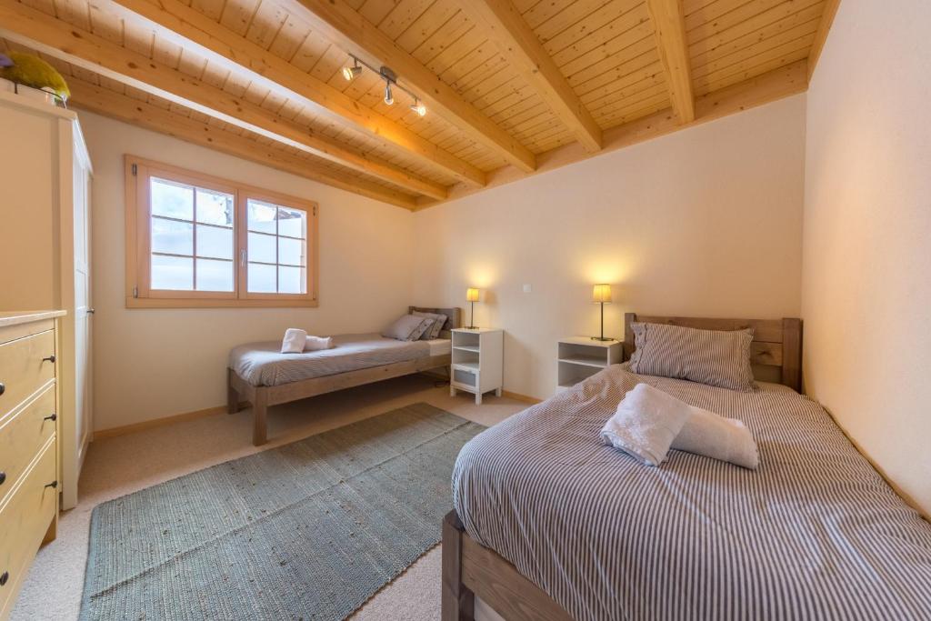 Postel nebo postele na pokoji v ubytování Chalet Nid Blanc