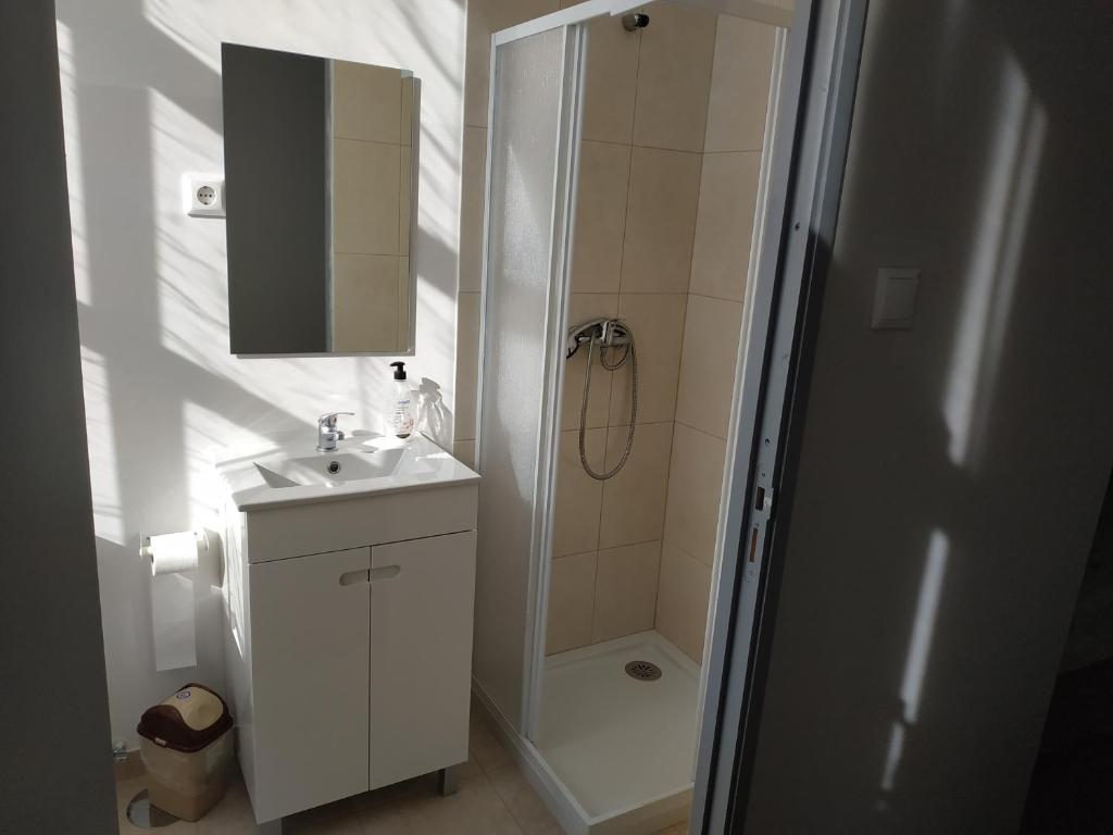 a bathroom with a sink, toilet and shower at Gabriel Guesthouse in Porto