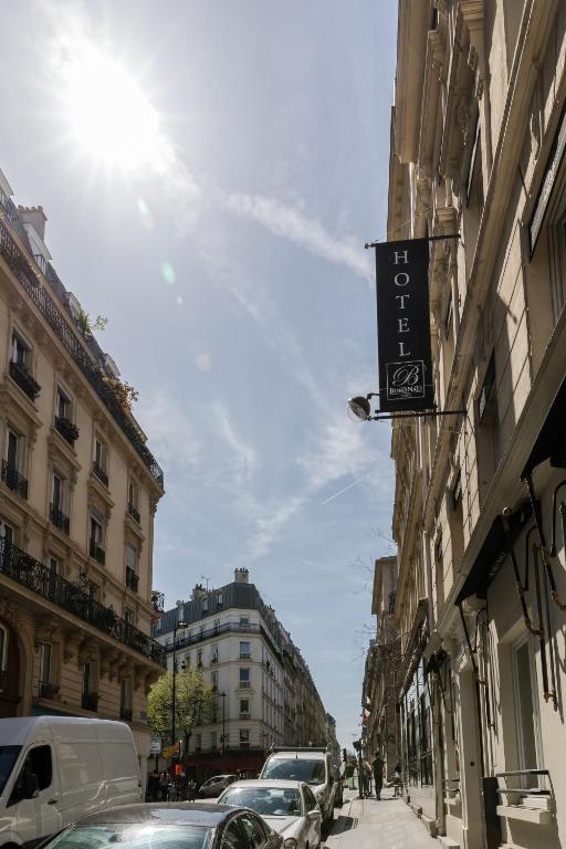 a street with cars parked on the side of buildings at Hotel Boronali in Paris