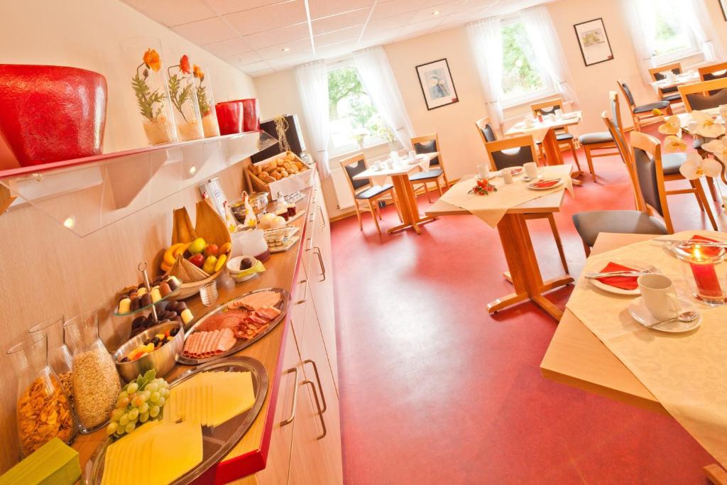 a restaurant with a buffet with fruits on it at meinHotel in Hamburg