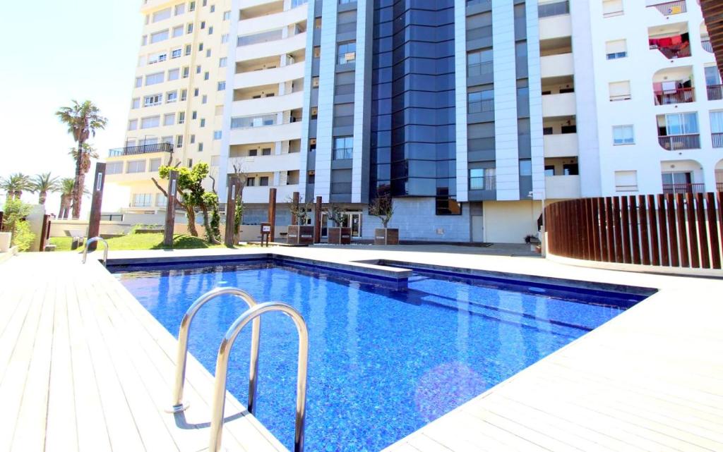 una piscina frente a un edificio en LEON INMO Apartment Oasis - 10022, en Empuriabrava