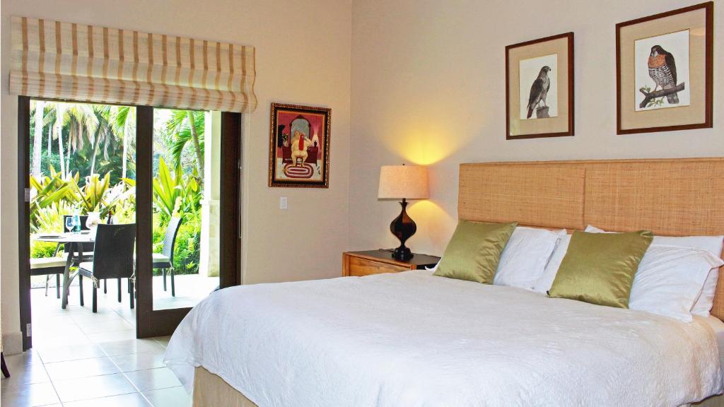 a bedroom with a bed and a table with a chair at Villa Athena in Rio Grande