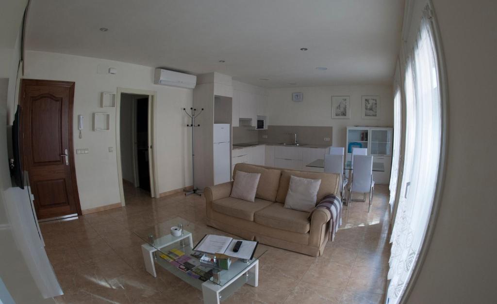 a living room with a couch and a table at Apartament Sant Quirze de Besora in Sant Quirze de Besora