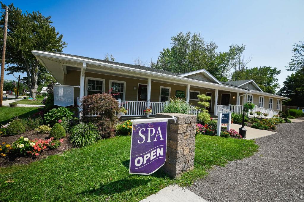 a house with a spa open sign in front of it at The Lakehouse Inn Geneva in Geneva-on-the-Lake