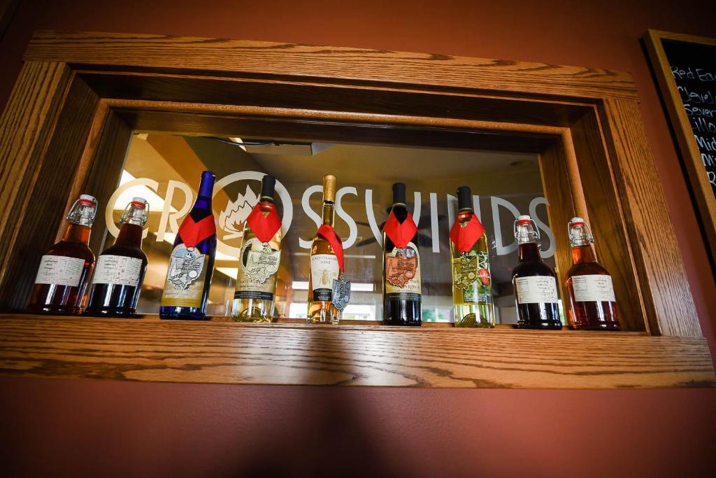 a shelf with a bunch of bottles of wine at The Lakehouse Inn Geneva in Geneva-on-the-Lake