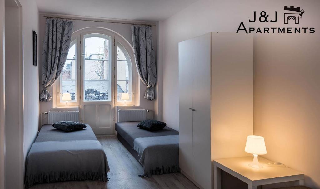 Posteľ alebo postele v izbe v ubytovaní J&J Apartments Łazienna 30 - 12