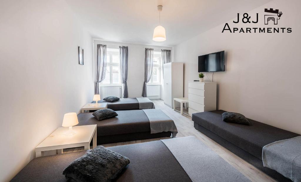 Posteľ alebo postele v izbe v ubytovaní J&J Apartments Łazienna 30 - 12