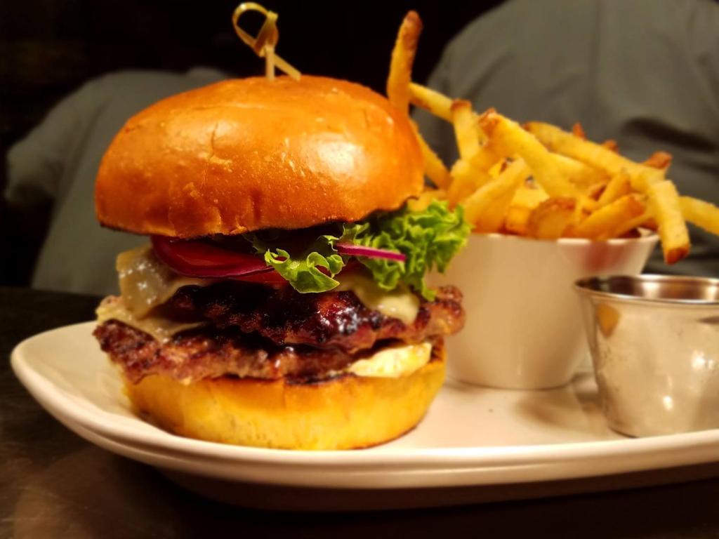 a cheeseburger and french fries on a white plate at The Lakehouse Inn Geneva in Geneva-on-the-Lake