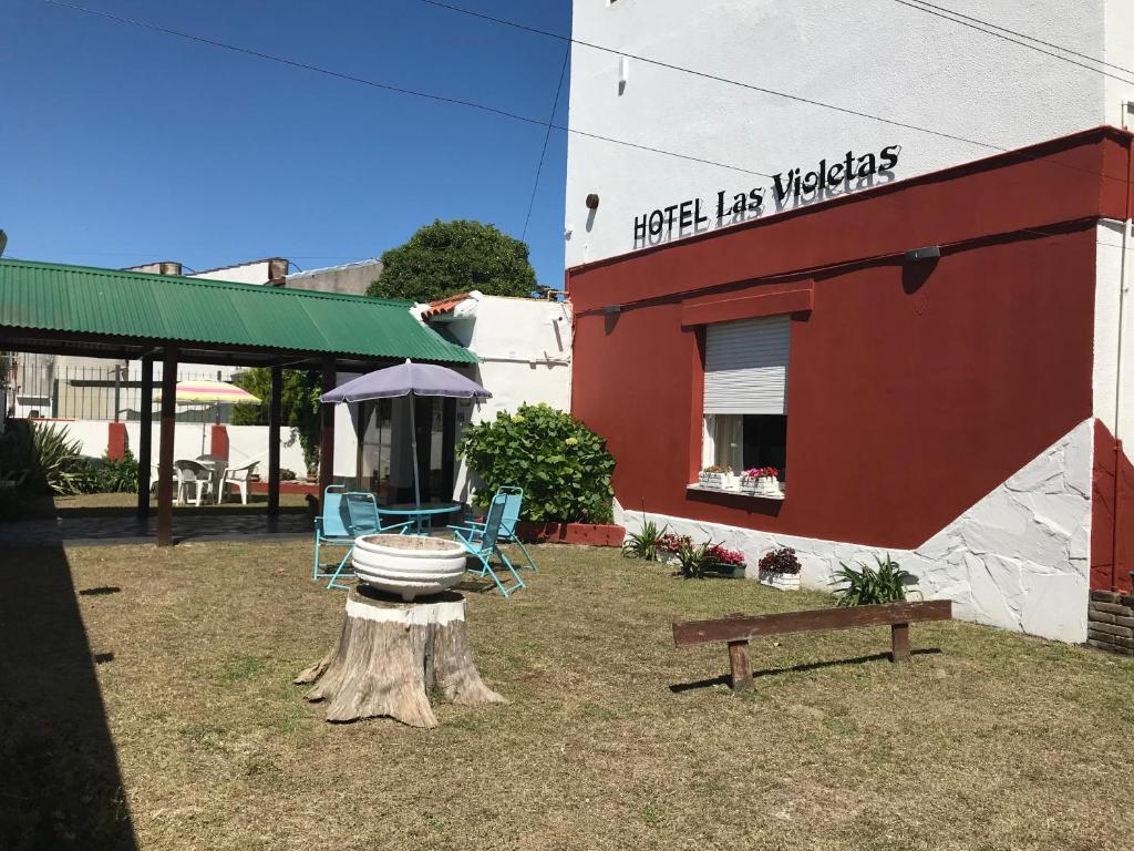 un edificio con 2 sillas y una mesa en el patio en Las Violetas en San Clemente del Tuyú