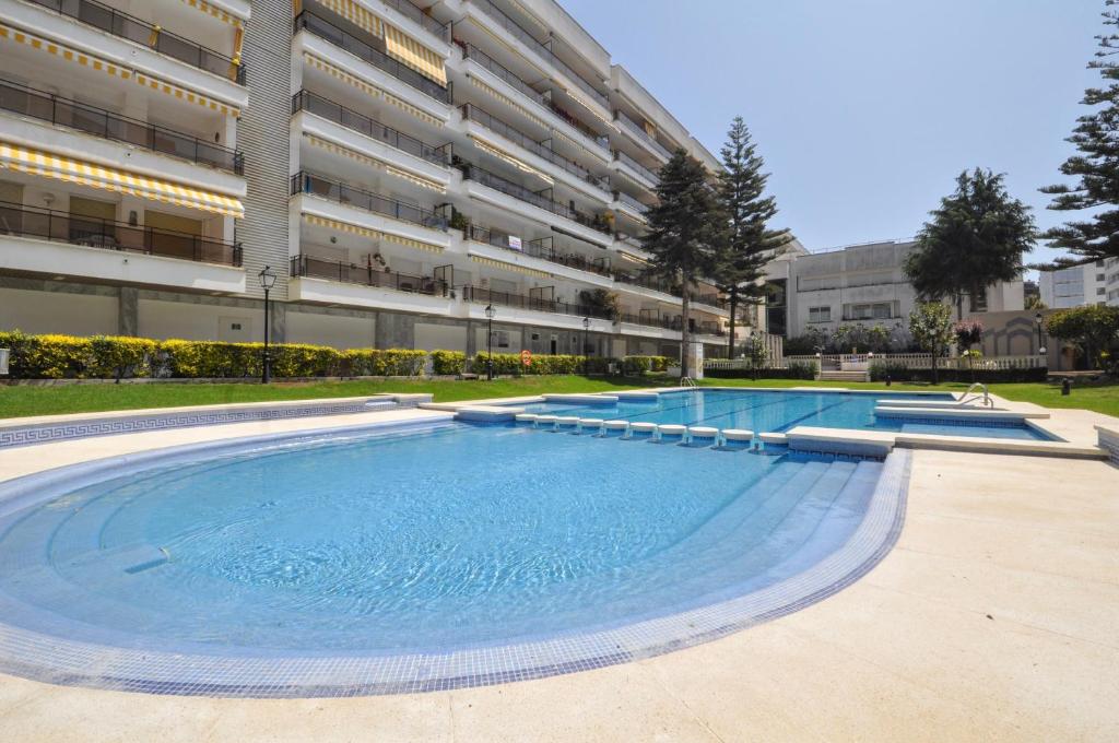 a large swimming pool in front of a building at Apartment Bonsol in Lloret de Mar