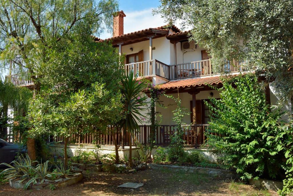 a house with a fence and trees in front of it at House Katia in Kalamos