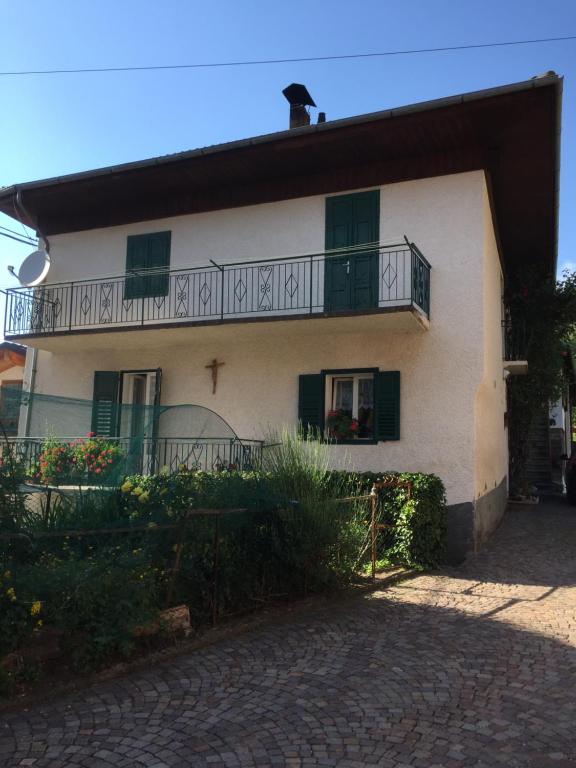 a white house with a balcony on top of it at Casa Sicina in Sicina