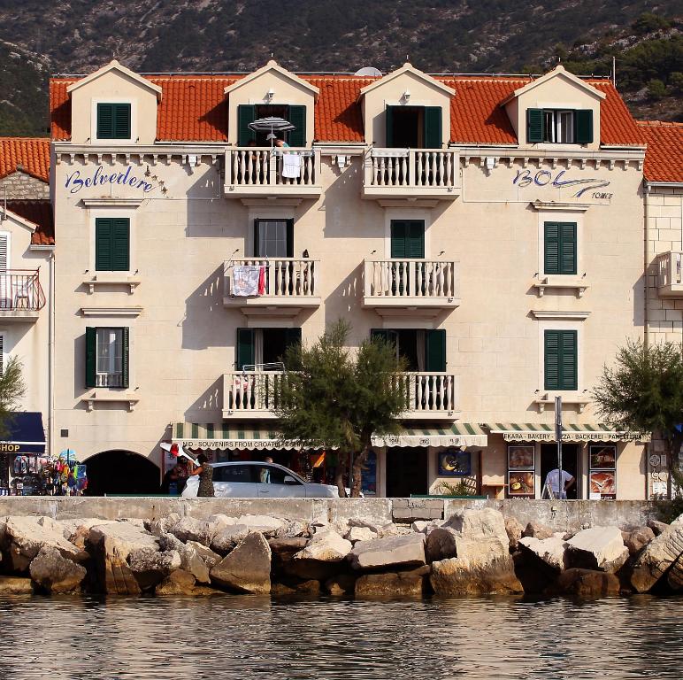 a large building next to a body of water at Apartments AMORE in Bol