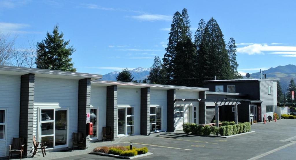 a row of buildings in a parking lot at Oxford Village Motels in Oxford
