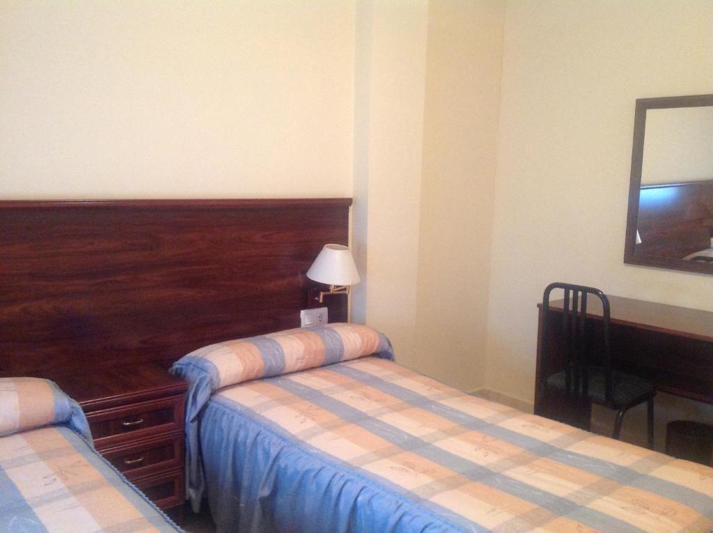 A bed or beds in a room at Hostal San Froilan