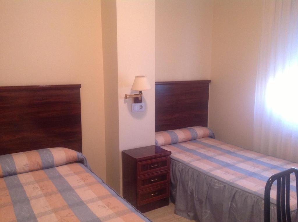 A bed or beds in a room at Hostal San Froilan