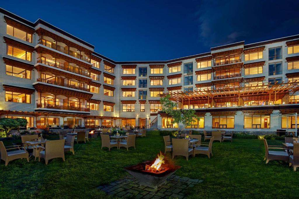 a hotel with a fire pit in the yard at The Grand Dragon Ladakh in Leh