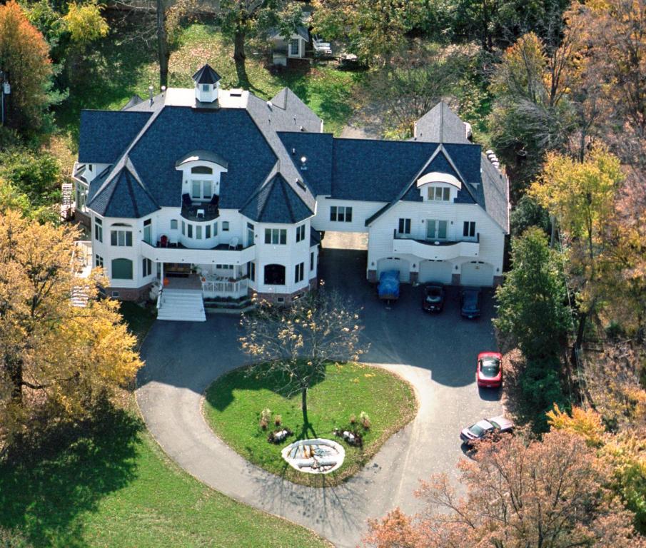 an aerial view of a large white house with a yard at The Columbia Inn at Peralynna in Columbia