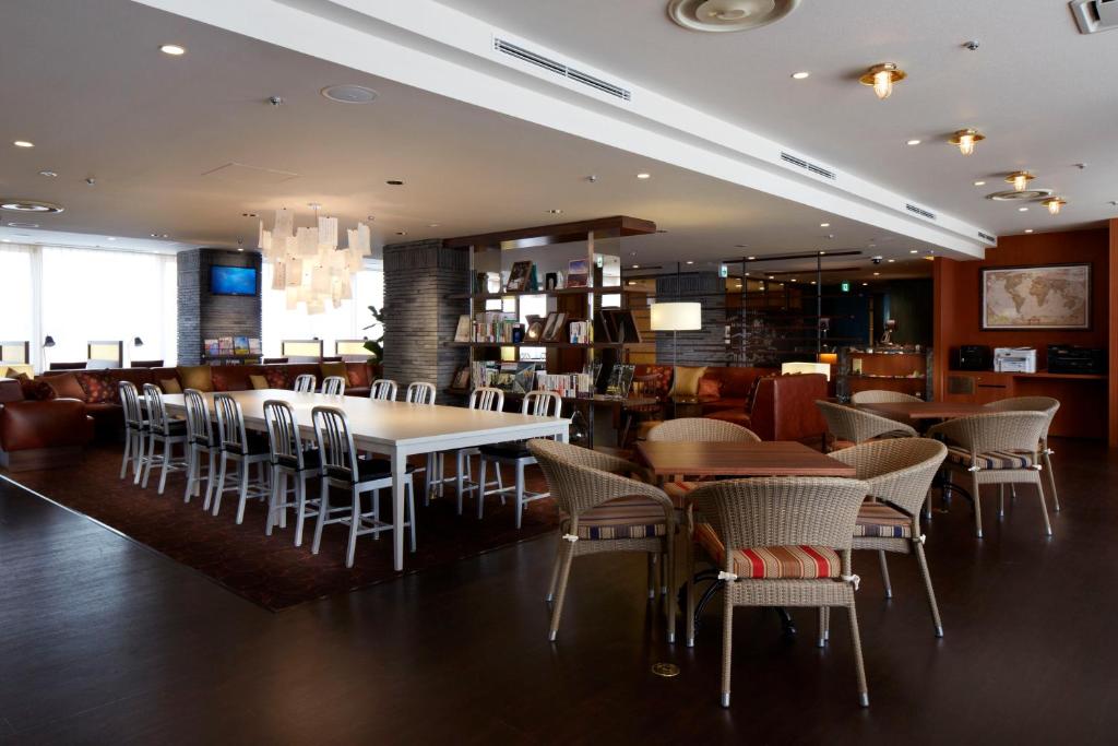 a dining room with tables and chairs in a restaurant at Shinagawa Prince Hotel N Tower in Tokyo