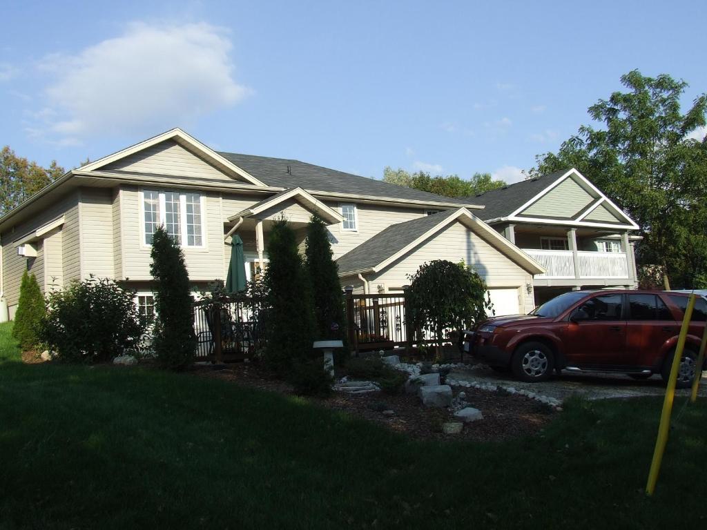 a house with a car parked in front of it at Hanna's House in Elora