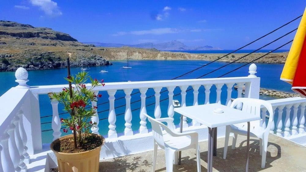 a balcony with a table and a view of the water at Villa Koki Studios in Lindos