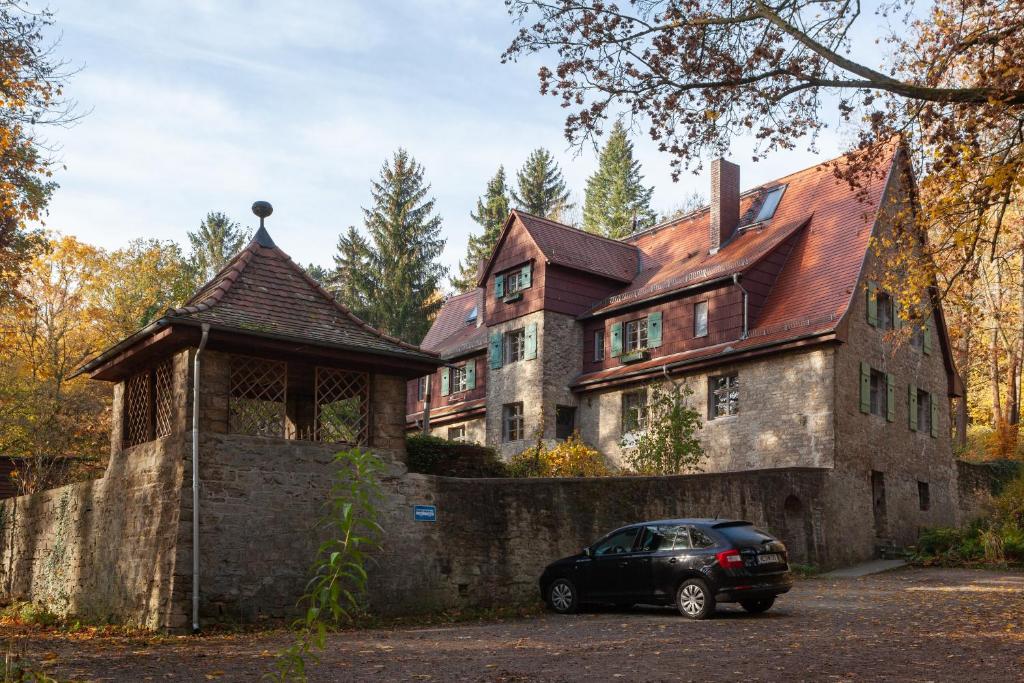 un'auto parcheggiata di fronte a una grande casa di Alte Falknerei a Weimar