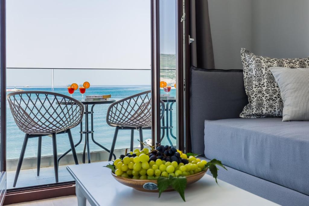 a living room with a bowl of fruit on a table at Olia Green Residence in Skopelos Town